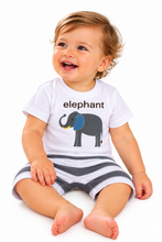 A smiling baby sitting on a white background wearing a white short-sleeve t-shirt with a gray and blue elephant graphic and the word 'elephant' printed above it, paired with gray and white striped shorts.