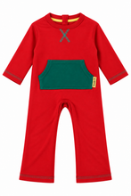 A red long-sleeve baby jumpsuit with a green front pocket, a gray X-shaped detail on the chest, and a small yellow tag on the pocket edge, shown against a plain white background.