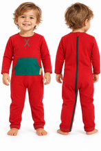 A toddler modeling a red one-piece footed pajama from the front and back against a white background. The front features a green chest pocket and a gray letter 'X' on the chest, while the back has a full-length green zipper.