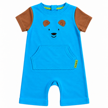 A toddler's short-sleeve romper in bright blue, featuring brown sleeves, a brown bear face on the chest, and a front kangaroo pocket.