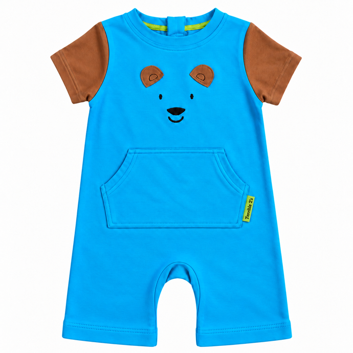 A toddler's short-sleeve romper in bright blue, featuring brown sleeves, a brown bear face on the chest, and a front kangaroo pocket.